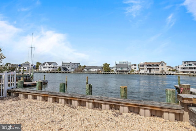 dock area featuring a residential view and a water view