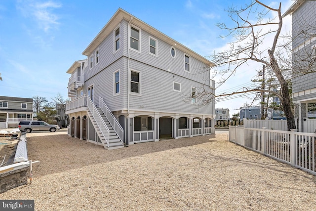 back of property featuring stairs and fence