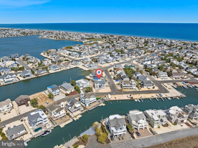 bird's eye view with a water view and a residential view