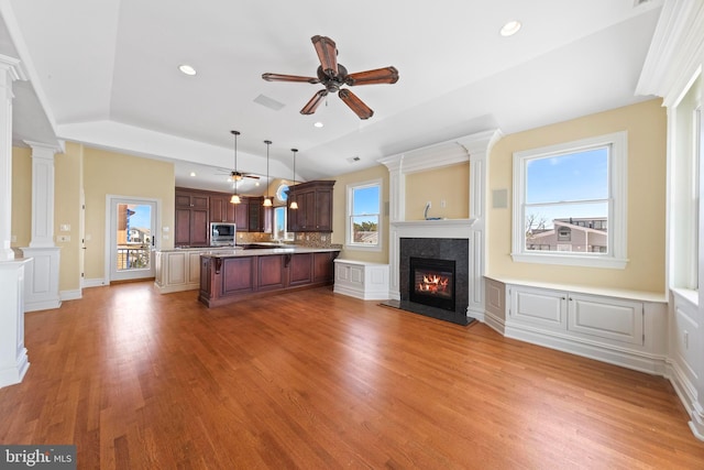 unfurnished living room featuring a premium fireplace, recessed lighting, ceiling fan, and light wood-type flooring