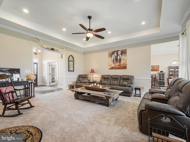 carpeted living room featuring ceiling fan, recessed lighting, ornamental molding, and a raised ceiling