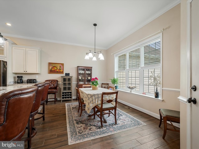 dining room featuring ornamental molding, baseboards, a notable chandelier, dark wood-style floors, and recessed lighting