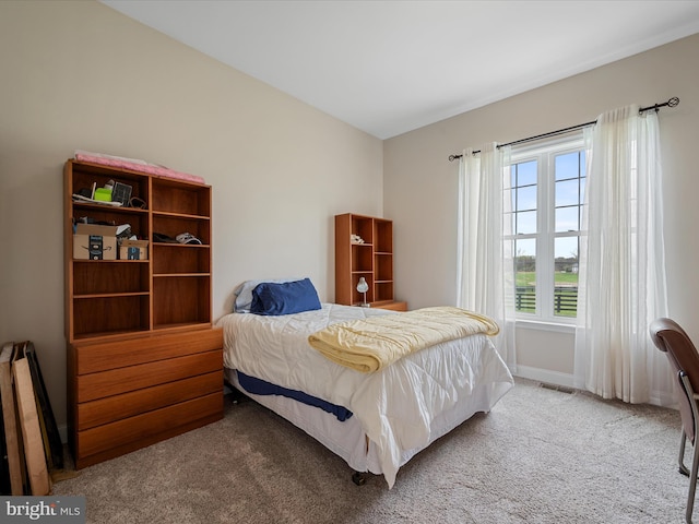carpeted bedroom featuring baseboards and visible vents