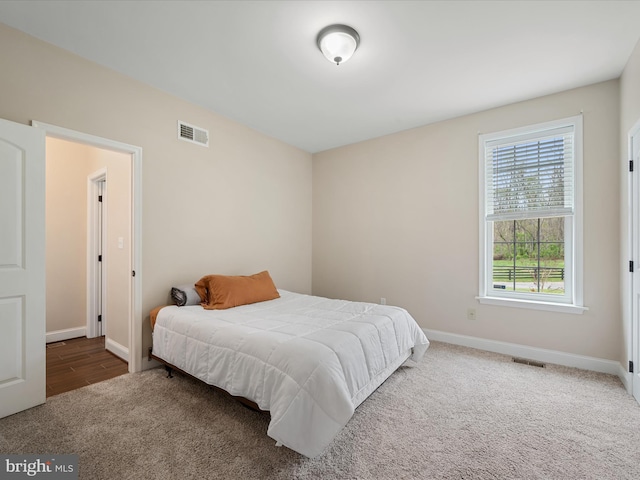 bedroom featuring visible vents, carpet flooring, and baseboards