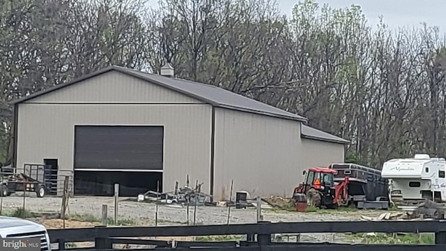 view of outbuilding featuring an outdoor structure and fence