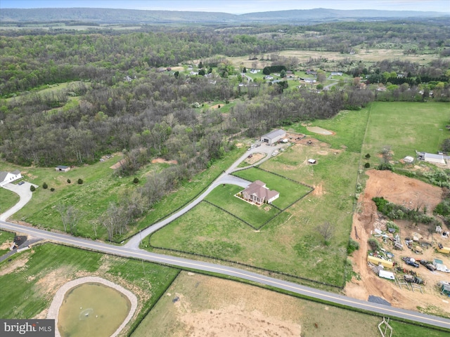 birds eye view of property featuring a forest view