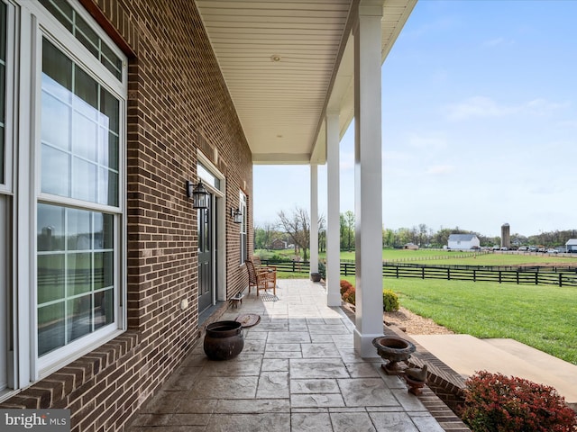 view of patio / terrace with fence and covered porch