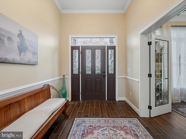 foyer with baseboards, wood finish floors, and crown molding