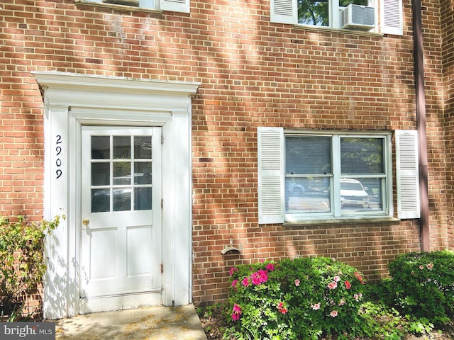 doorway to property with brick siding
