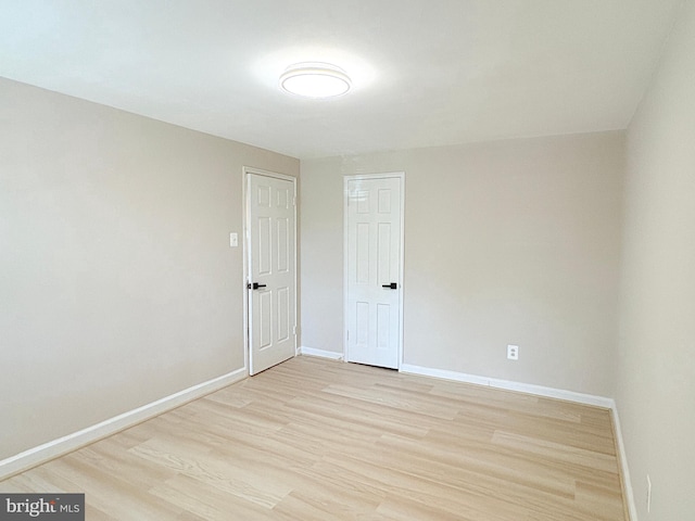 unfurnished room featuring light wood-style floors and baseboards