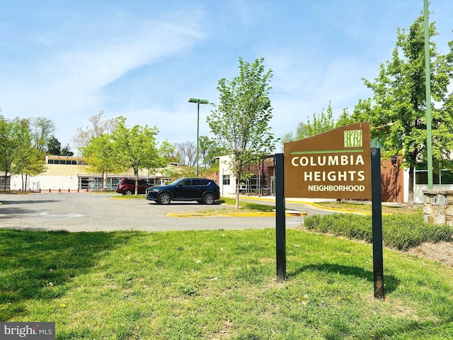 exterior space featuring uncovered parking and a yard