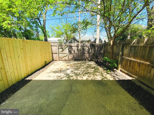 view of yard with a gate, fence private yard, and a patio