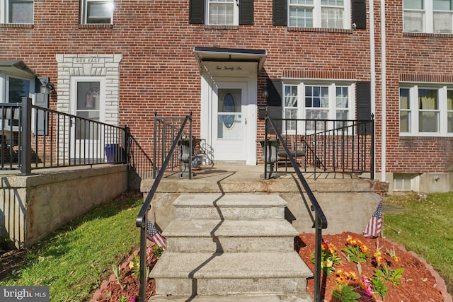 property entrance with brick siding