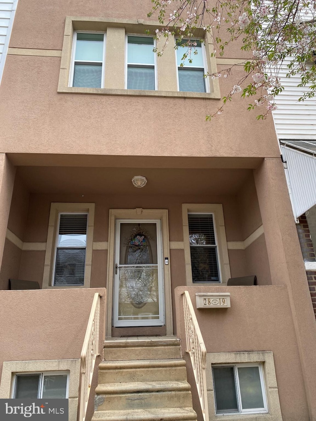 property entrance with stucco siding