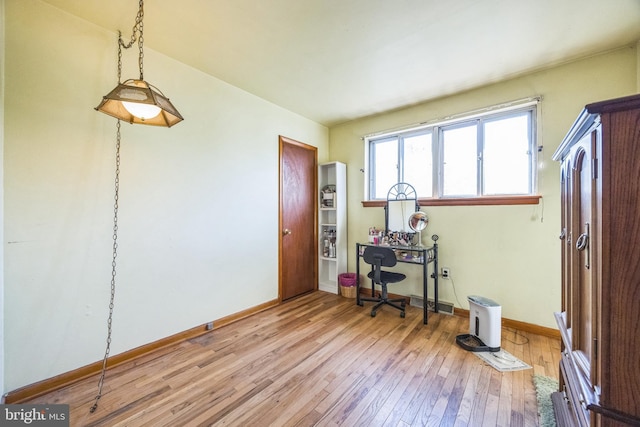 office area with light wood finished floors and baseboards
