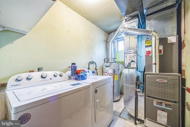 washroom with water heater, washer and dryer, light tile patterned flooring, and heating unit