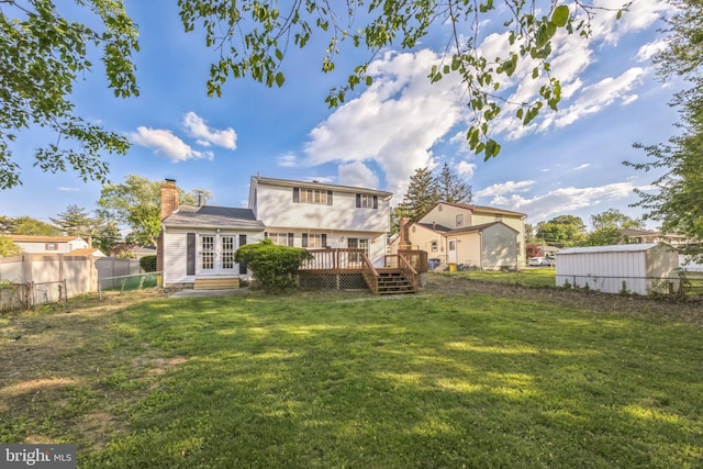 back of house with a wooden deck, french doors, and a chimney