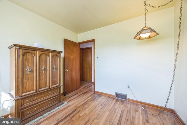 unfurnished bedroom featuring light wood-style floors and baseboards
