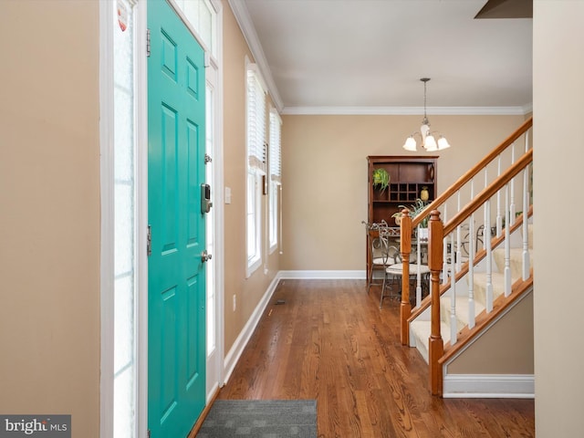3325 Cedar Dr, Edgewater, MD 21037 - foyer entrance with crown molding, wood finished floors, stairway, baseboards, and a notable chandelier