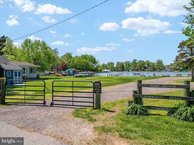 3325 Cedar Dr, Edgewater, MD 21037 - view of gate featuring a water view, fence, and a yard