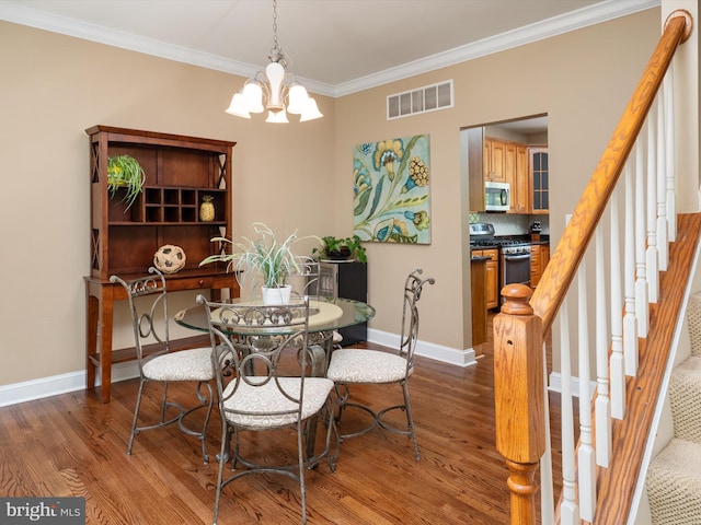 3325 Cedar Dr, Edgewater, MD 21037 - dining space with an inviting chandelier, wood finished floors, visible vents, ornamental molding, and stairway