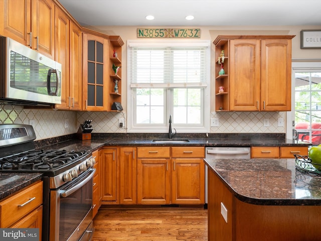 3325 Cedar Dr, Edgewater, MD 21037 - kitchen with open shelves, appliances with stainless steel finishes, a sink, light wood finished floors, and dark stone countertops