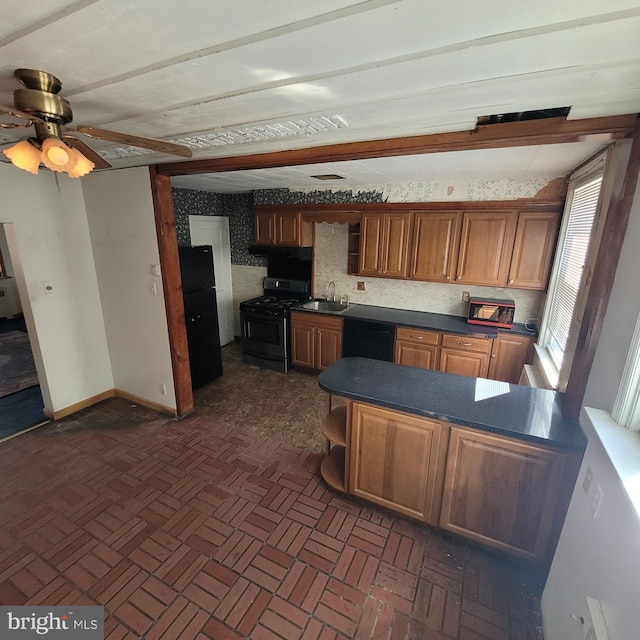 kitchen with a sink, black dishwasher, open shelves, dark countertops, and stainless steel gas range oven