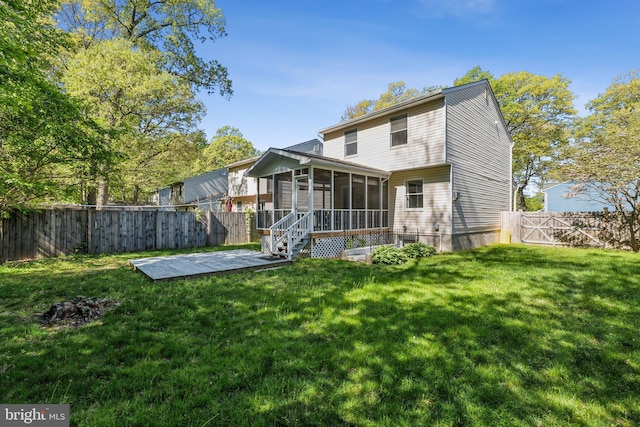 rear view of house with a sunroom, a fenced backyard, and a lawn