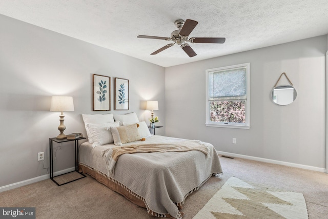 bedroom with baseboards, ceiling fan, visible vents, and light carpet