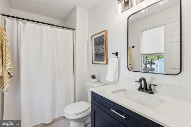 bathroom with a shower with curtain, a textured ceiling, tile patterned flooring, vanity, and toilet