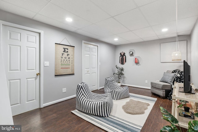 interior space featuring recessed lighting, baseboards, dark wood finished floors, and a paneled ceiling