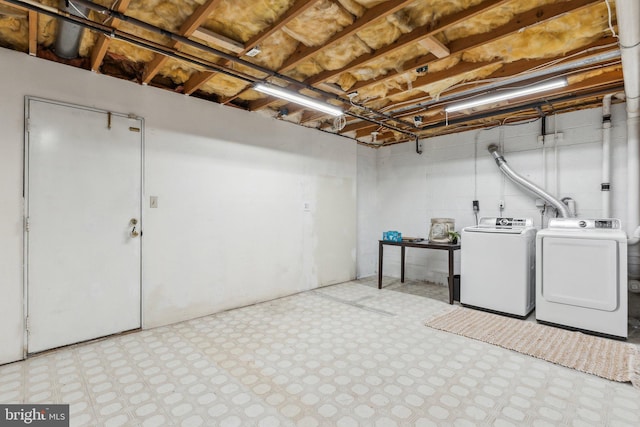 laundry room featuring washing machine and clothes dryer, laundry area, and tile patterned floors