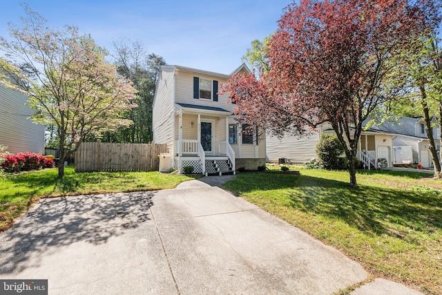 view of front of home with a front lawn and fence