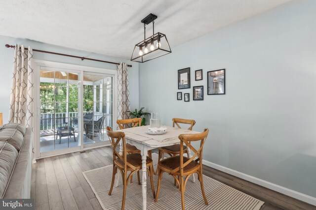 dining space featuring baseboards and wood finished floors