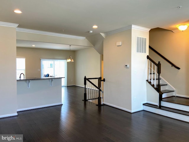 unfurnished living room with ornamental molding, recessed lighting, visible vents, and dark wood-type flooring