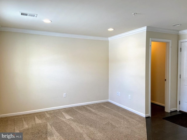 spare room with visible vents, baseboards, ornamental molding, carpet, and recessed lighting