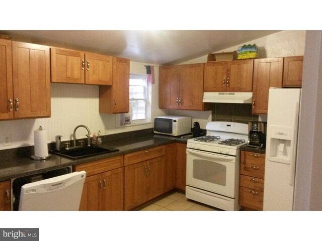 625 Lamberton St, Trenton, NJ 08611 - kitchen featuring dark countertops, a sink, white appliances, lofted ceiling, and under cabinet range hood