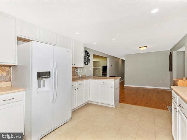 13240 Edgemont Rd, Smithsburg, MD 21783 - kitchen with white refrigerator with ice dispenser, open floor plan, light countertops, a peninsula, and recessed lighting