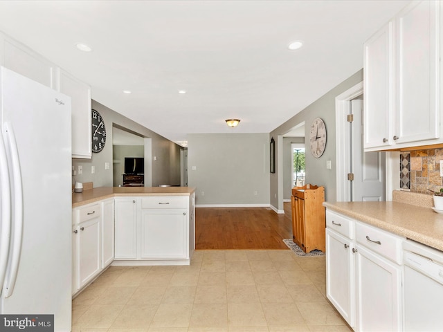 13240 Edgemont Rd, Smithsburg, MD 21783 - kitchen with white appliances, light countertops, white cabinetry, a peninsula, and baseboards