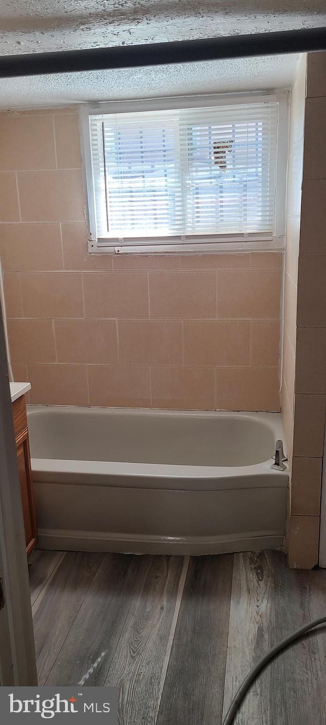full bathroom featuring vanity and wood finished floors