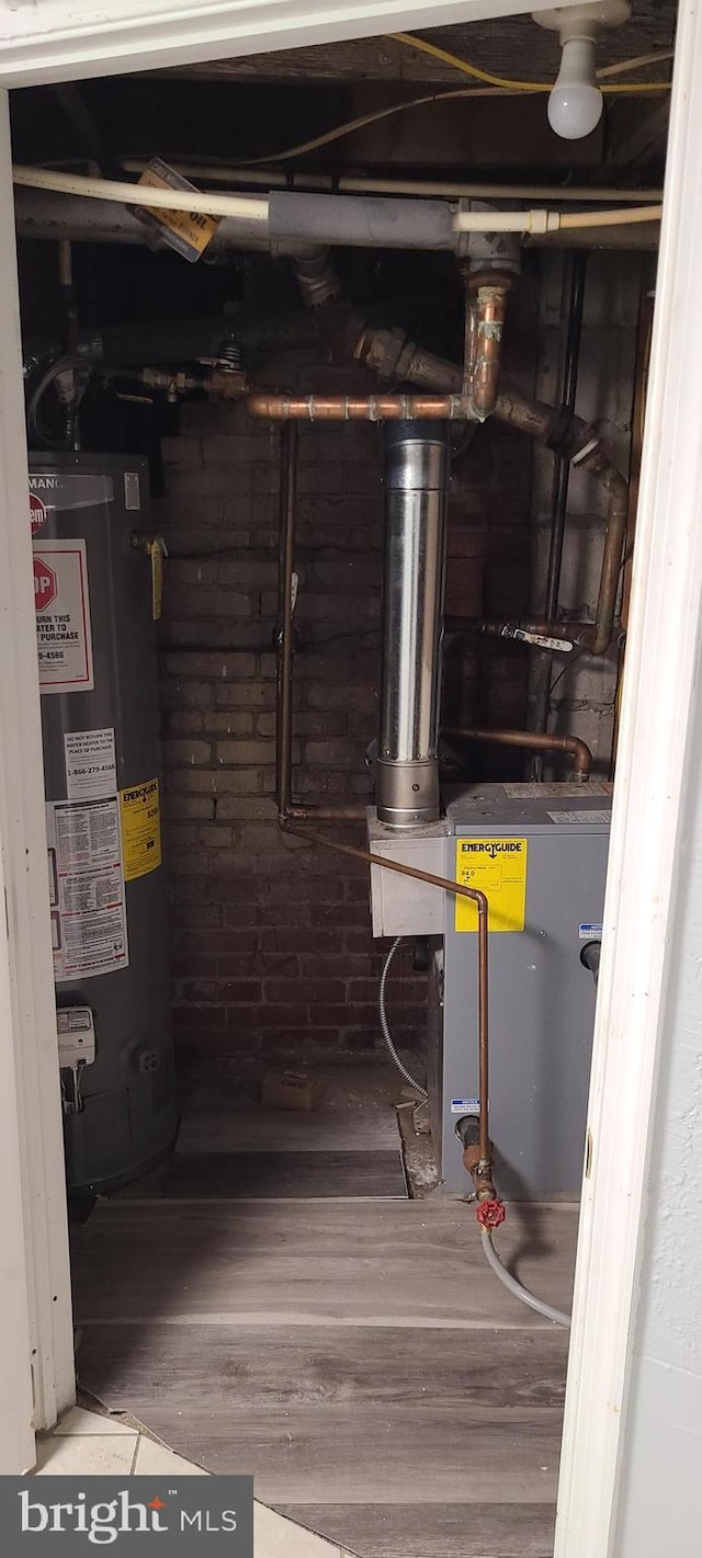 utility room featuring gas water heater