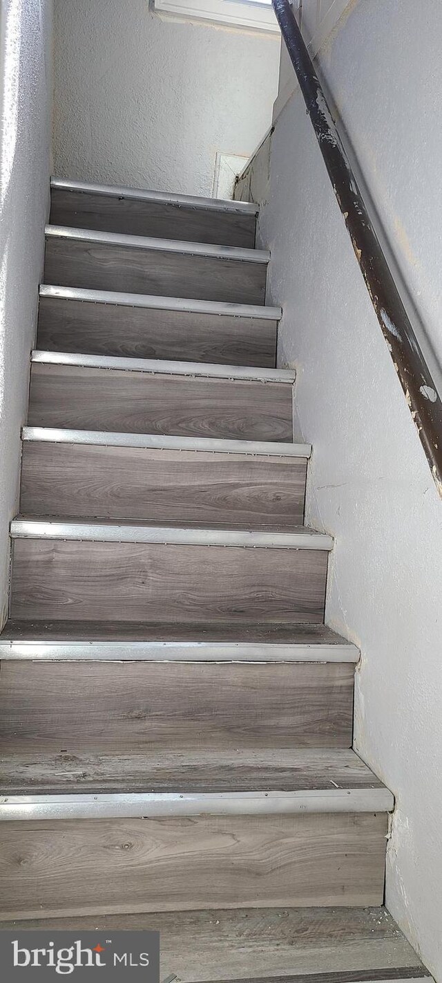 stairway with a textured wall