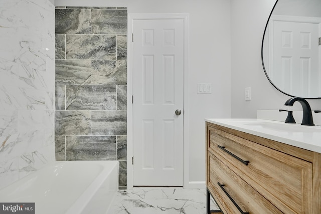 full bathroom featuring marble finish floor and vanity