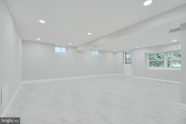 basement with plenty of natural light, baseboards, and recessed lighting