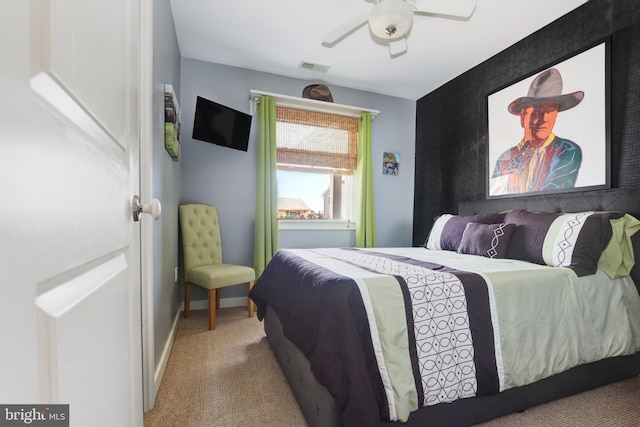 carpeted bedroom featuring baseboards, ceiling fan, and visible vents