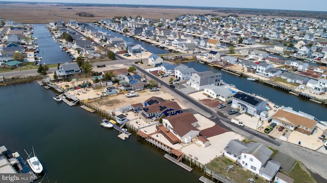 drone / aerial view featuring a water view and a residential view