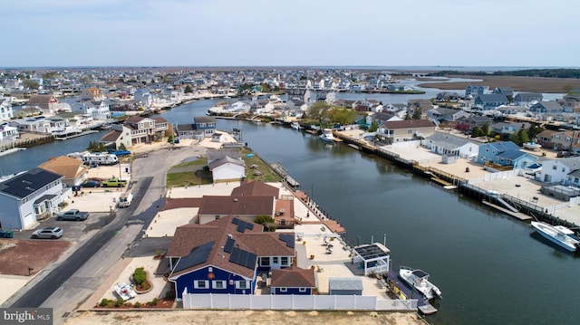 drone / aerial view with a residential view and a water view