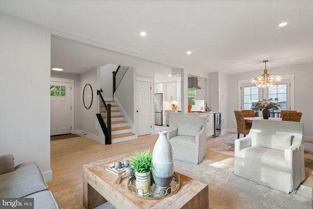 3838 13th St N, Arlington, VA 22201 - living area featuring a chandelier, stairway, wine cooler, light wood-style flooring, and plenty of natural light