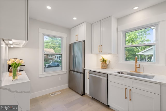 3838 13th St N, Arlington, VA 22201 - kitchen featuring appliances with stainless steel finishes, a sink, plenty of natural light, white cabinets, and recessed lighting