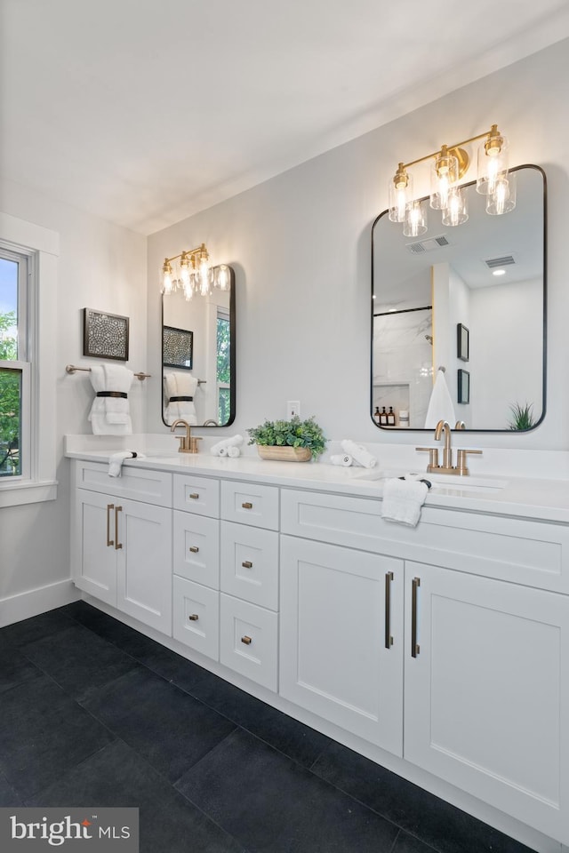 3838 13th St N, Arlington, VA 22201 - bathroom with tile patterned flooring, double vanity, baseboards, and a chandelier